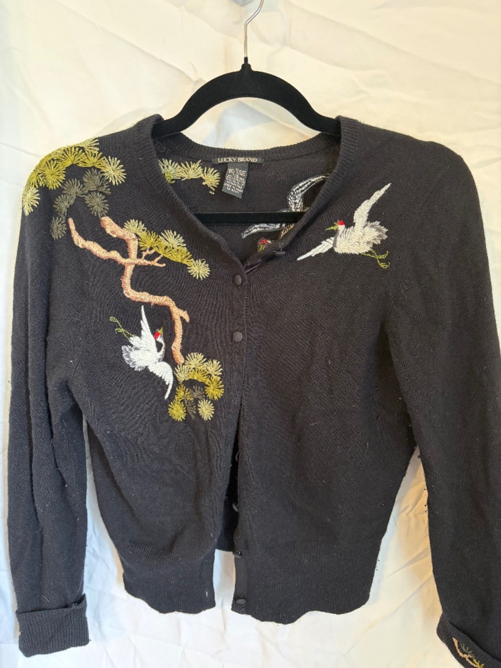 Embroidered black sweater with crane motif